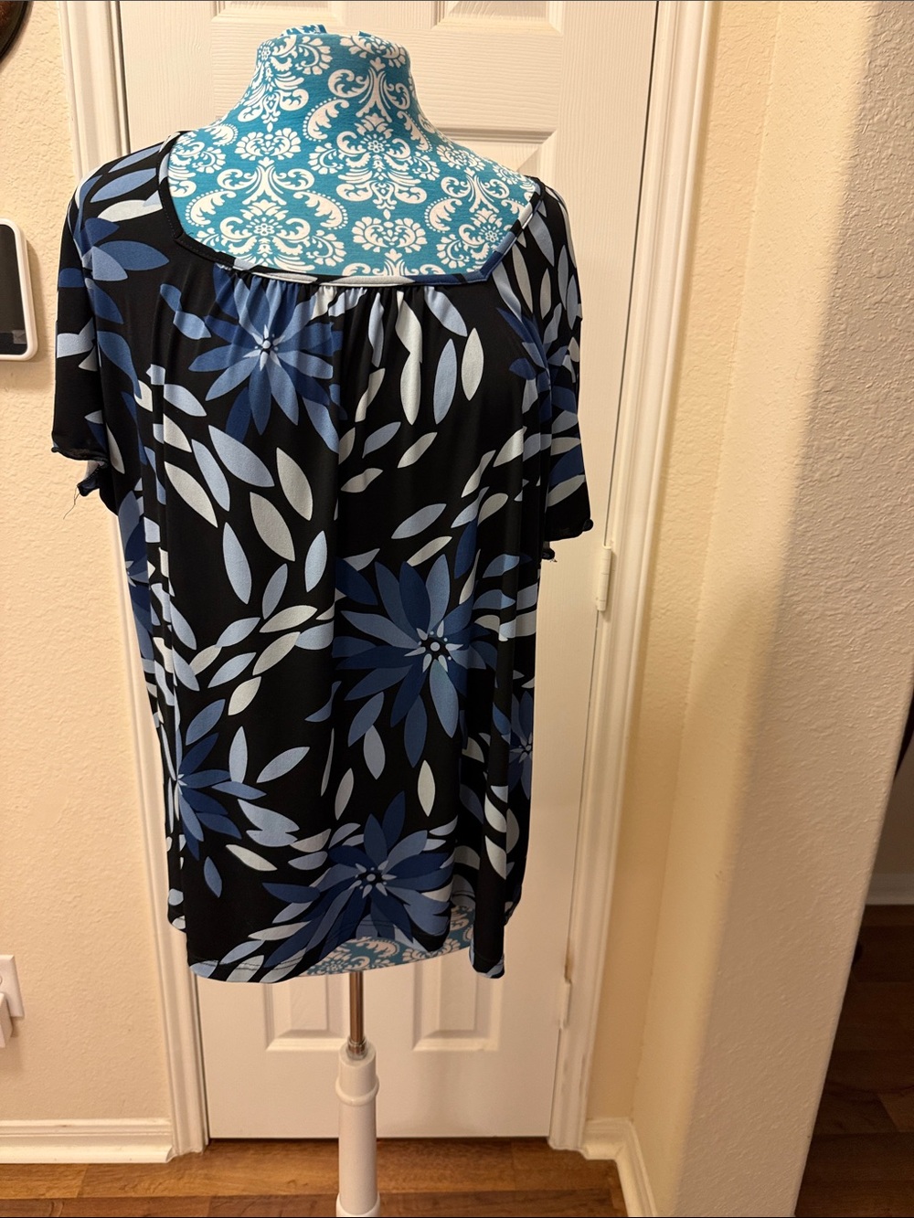 Suzie In The City Black Top with Blue Floral Motif